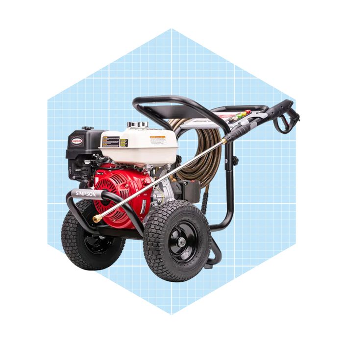 A pressure washer rests on two wheels, ready for use. It features a red engine, a long hose, and a spray wand against a light grid background.