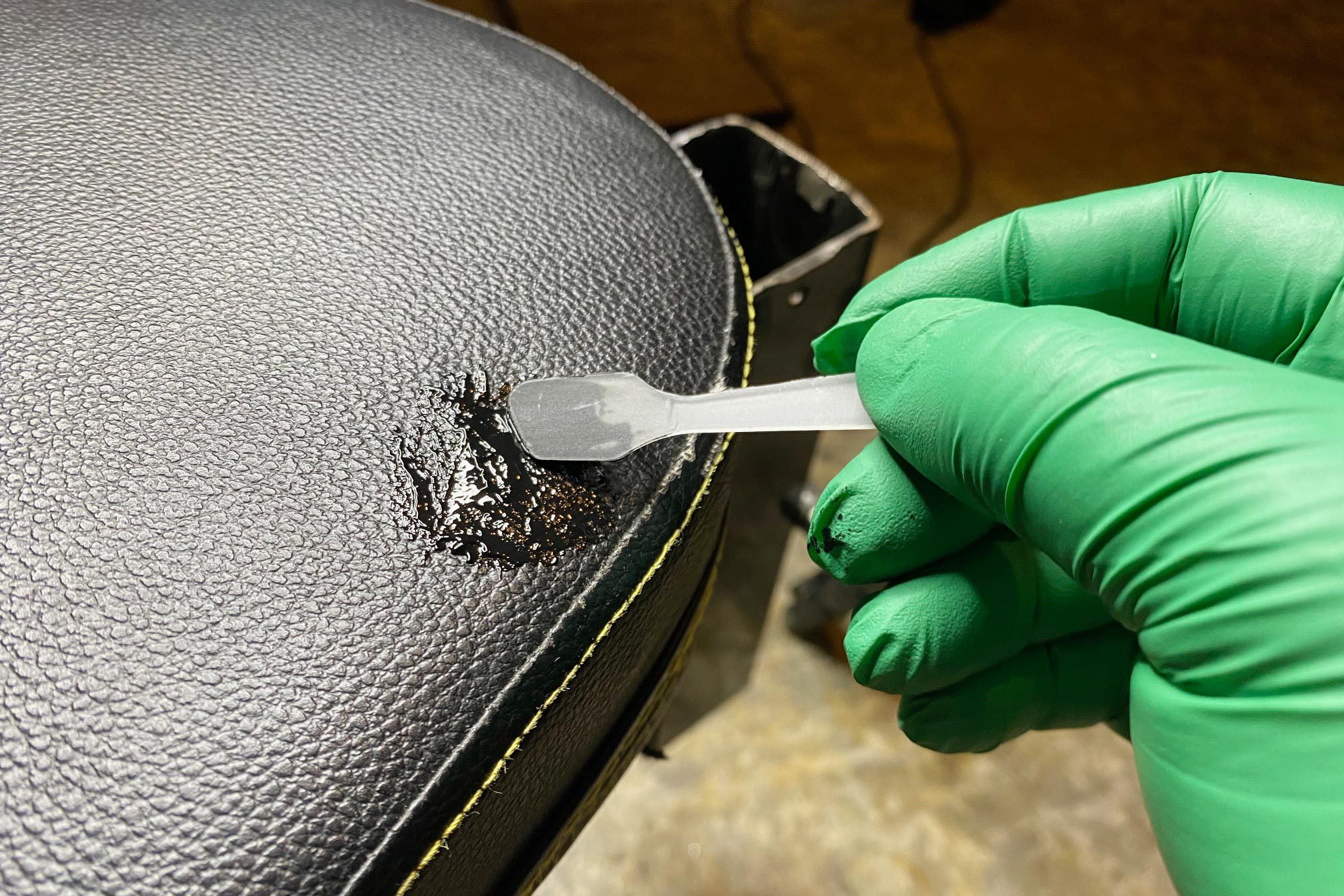 putting Repair Compound onto the cushion using a little spatula