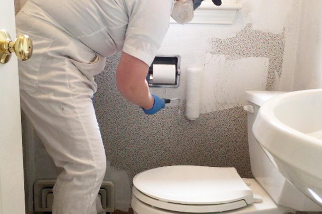 painting on primer on wallpaper with roller