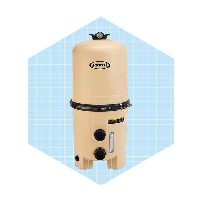 A tan Jacuzzi filter stands upright, equipped with a pressure gauge on top, situated against a light blue grid background.