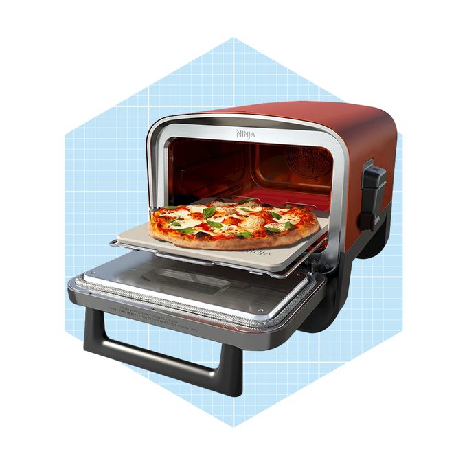 A countertop oven displays a pizza on a stone tray, with the door open, set against a light blue grid background.