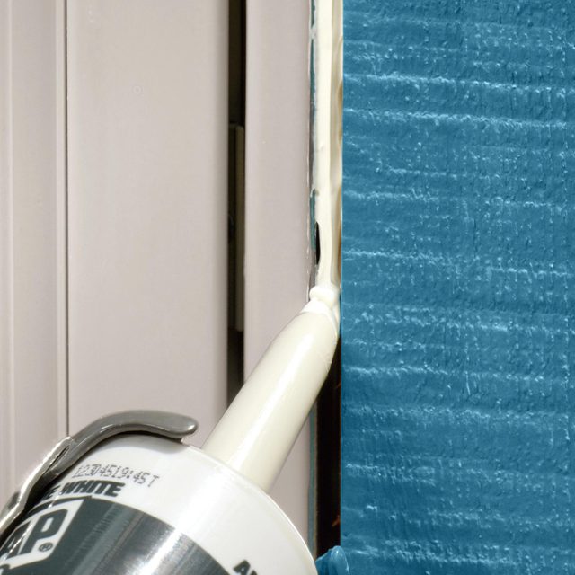 Applying caulk on the window