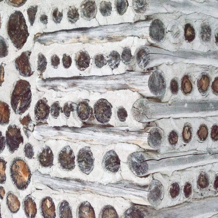 Antique Cordwood Log Cabin Gingerbread House in the snow Made of Cord wood