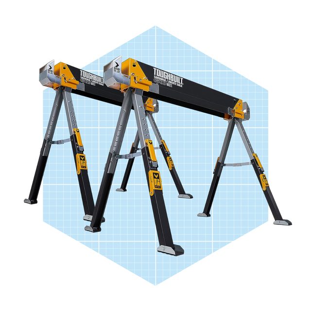 A sturdy, adjustable sawhorse supports a long work surface, set against a light blue grid background, indicating a workspace for construction or crafting activities.