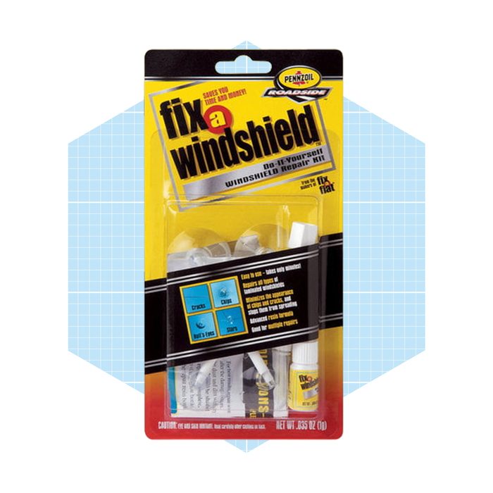A windshield repair kit is displayed, containing various components for fixing cracks and chips. It