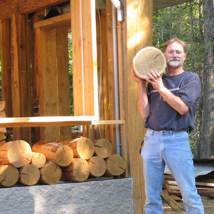 Richard At Cec holding a log