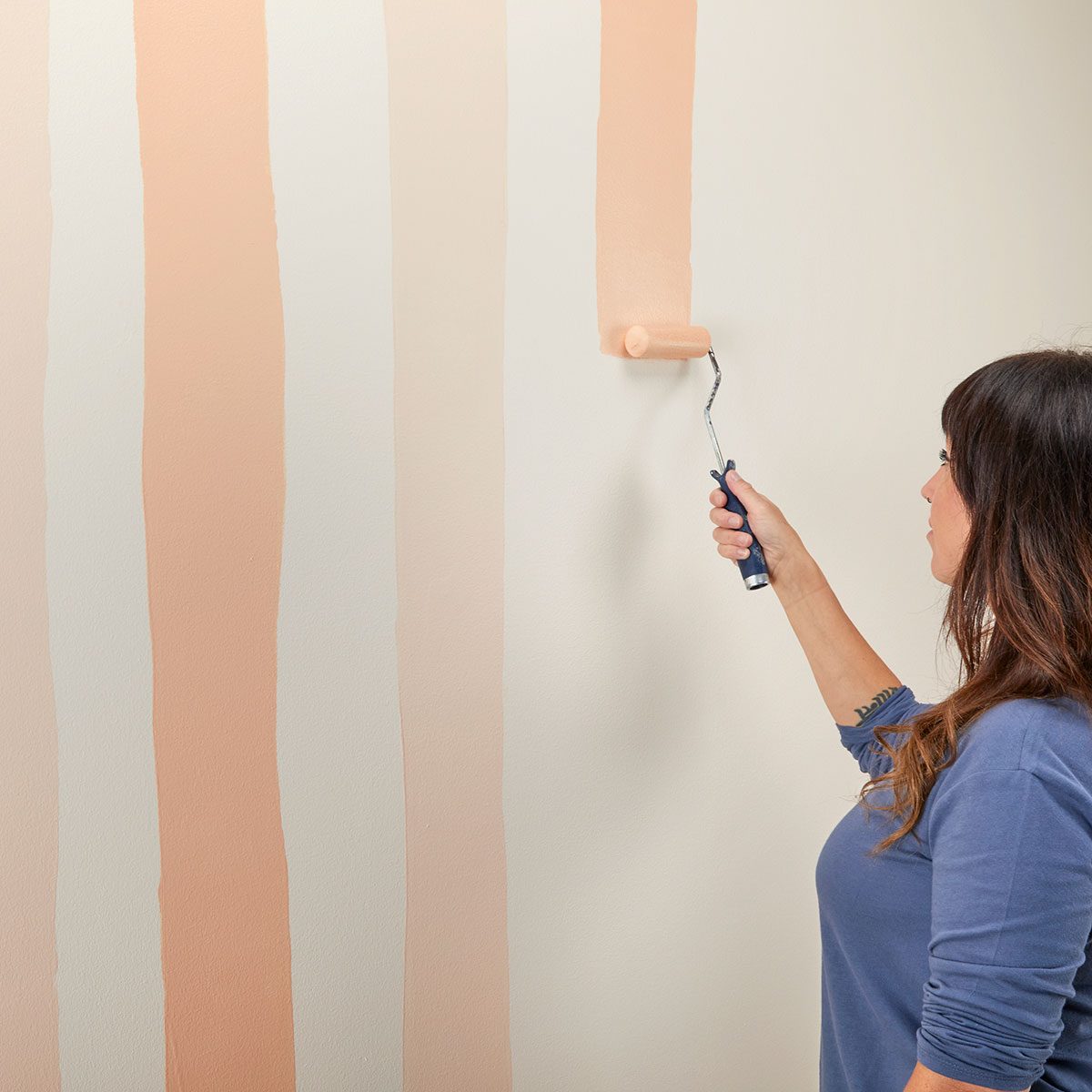 Lady Painting Wall with Paint Roller