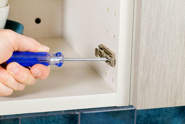 fastening the screw with a screwdriver