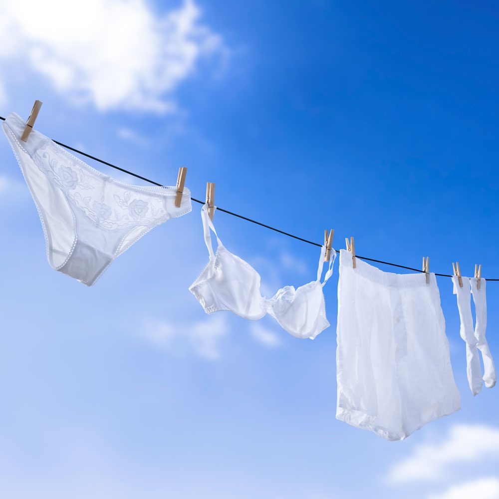 Male and Female White Underwear Hanging In Clear Blue Sky