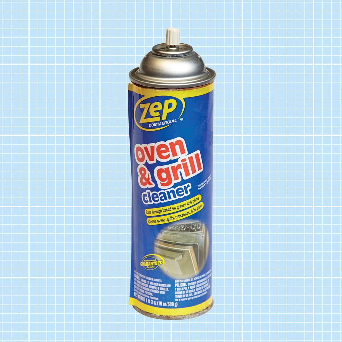 A spray can labeled "Zep Commercial oven & grill cleaner" is prominently displayed, designed to remove baked-on grease, set against a light blue grid background.