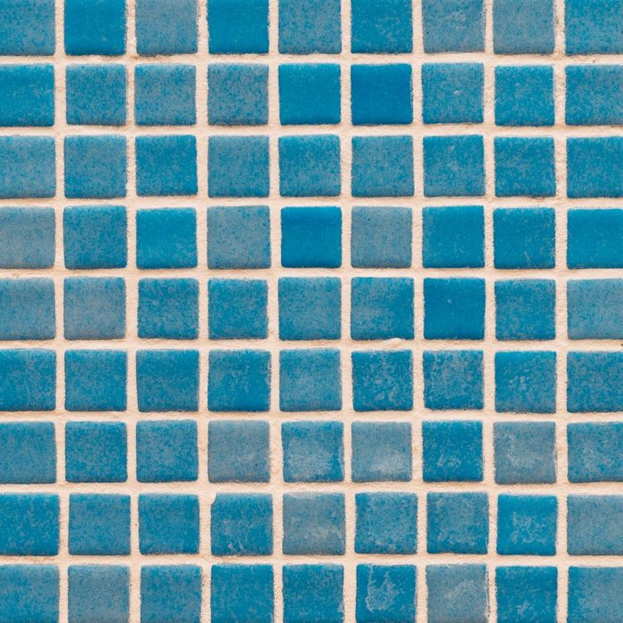 Square tile background at the bottom of a swimming pool.