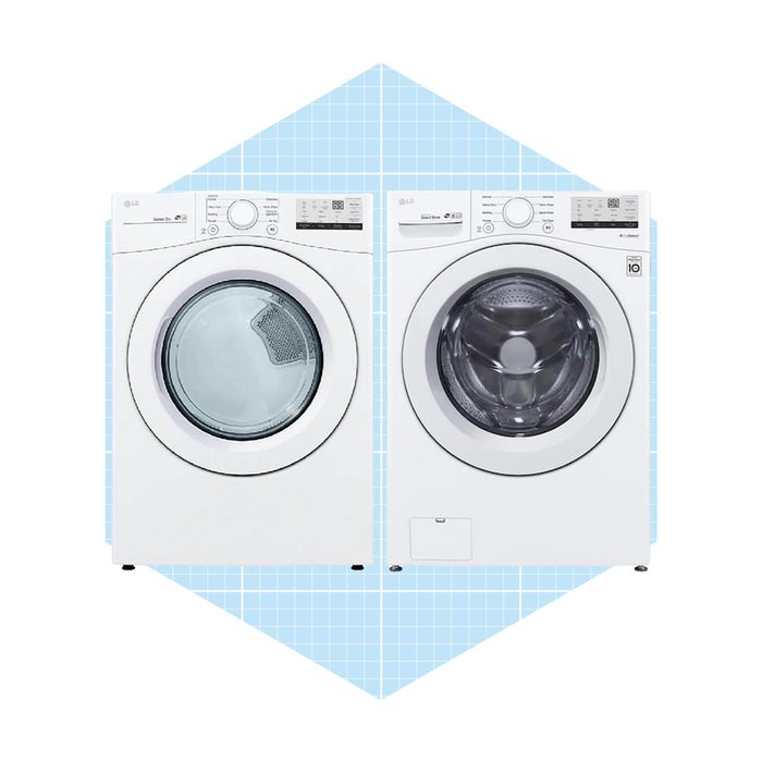 Two white laundry machines, a washing machine and a dryer, stand side by side on a light blue grid background.