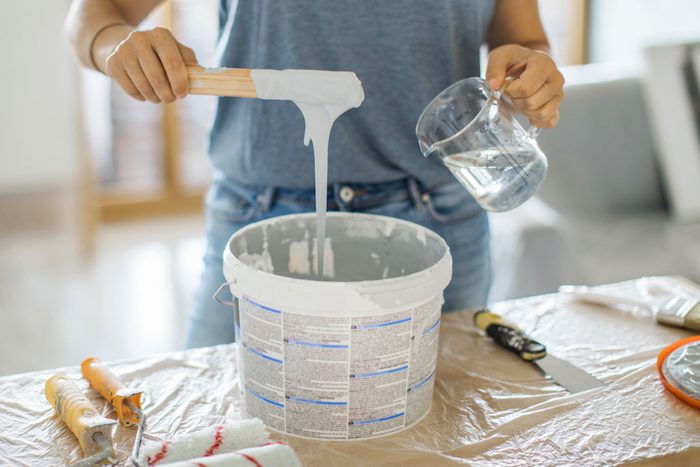 Woman Adding Water In Paint