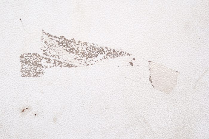 sticky residue on white fridge left from a piece of tape