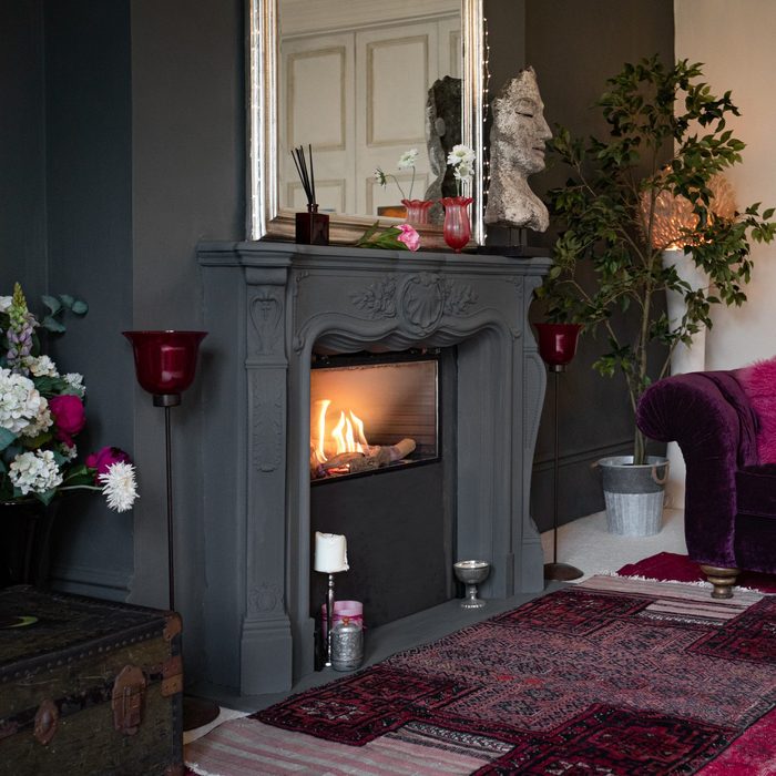 Living room with dark walls and authentic fireplace