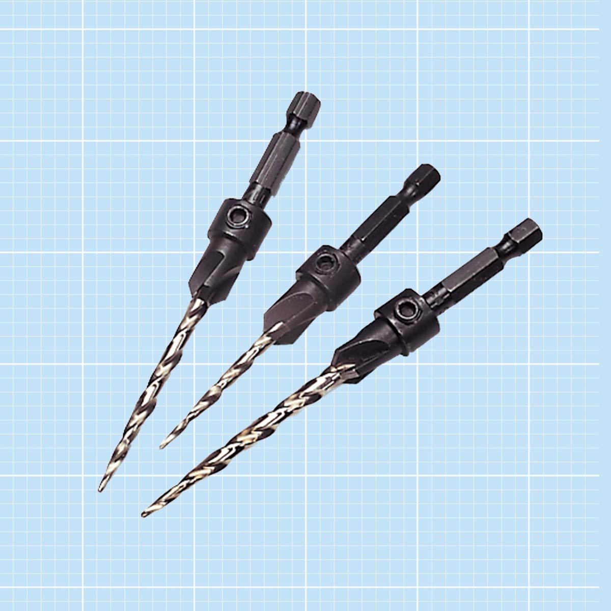 Three countersink drill bits on a blue grid background