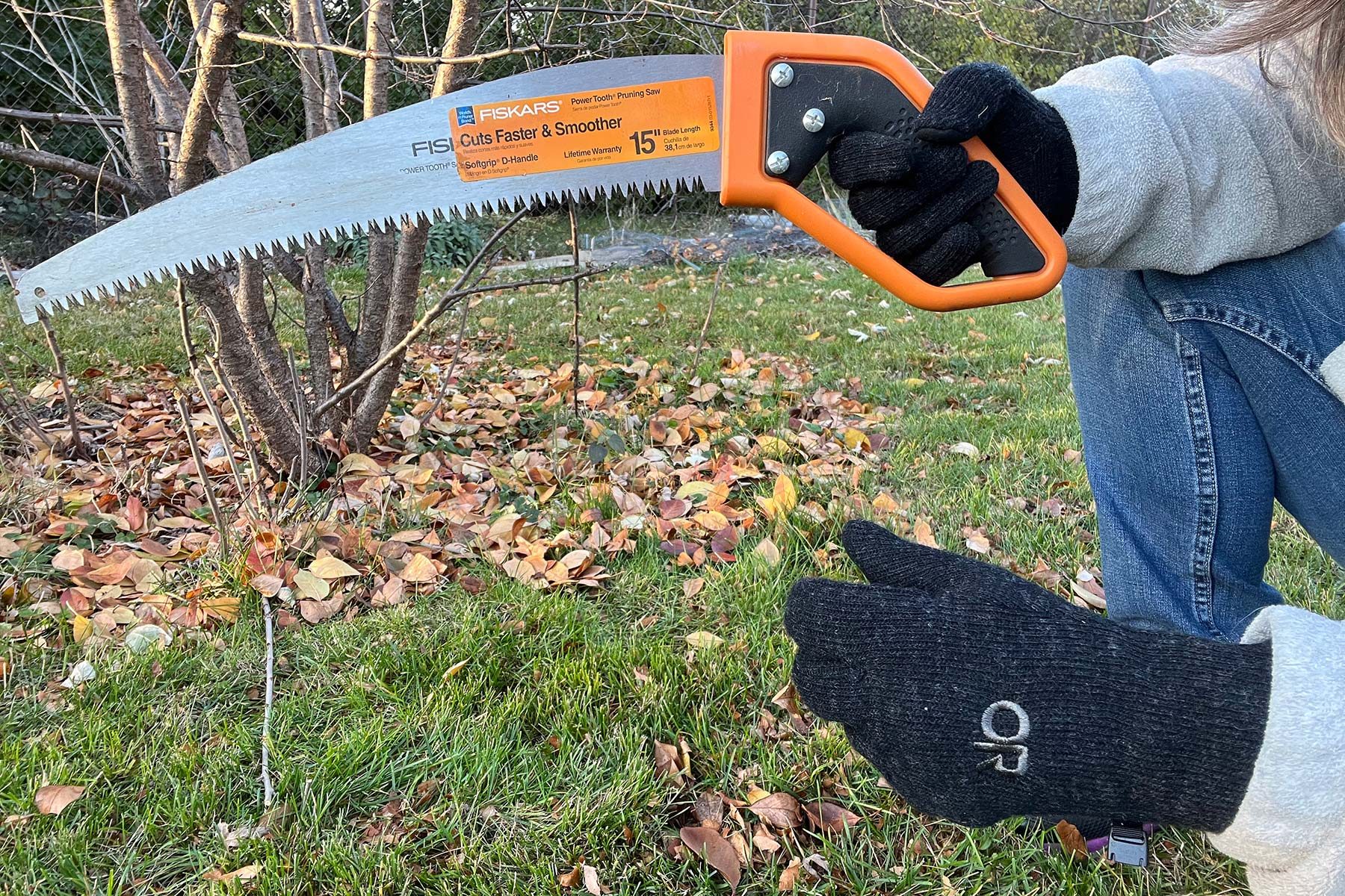 Holding hand saw while wearing gloves
