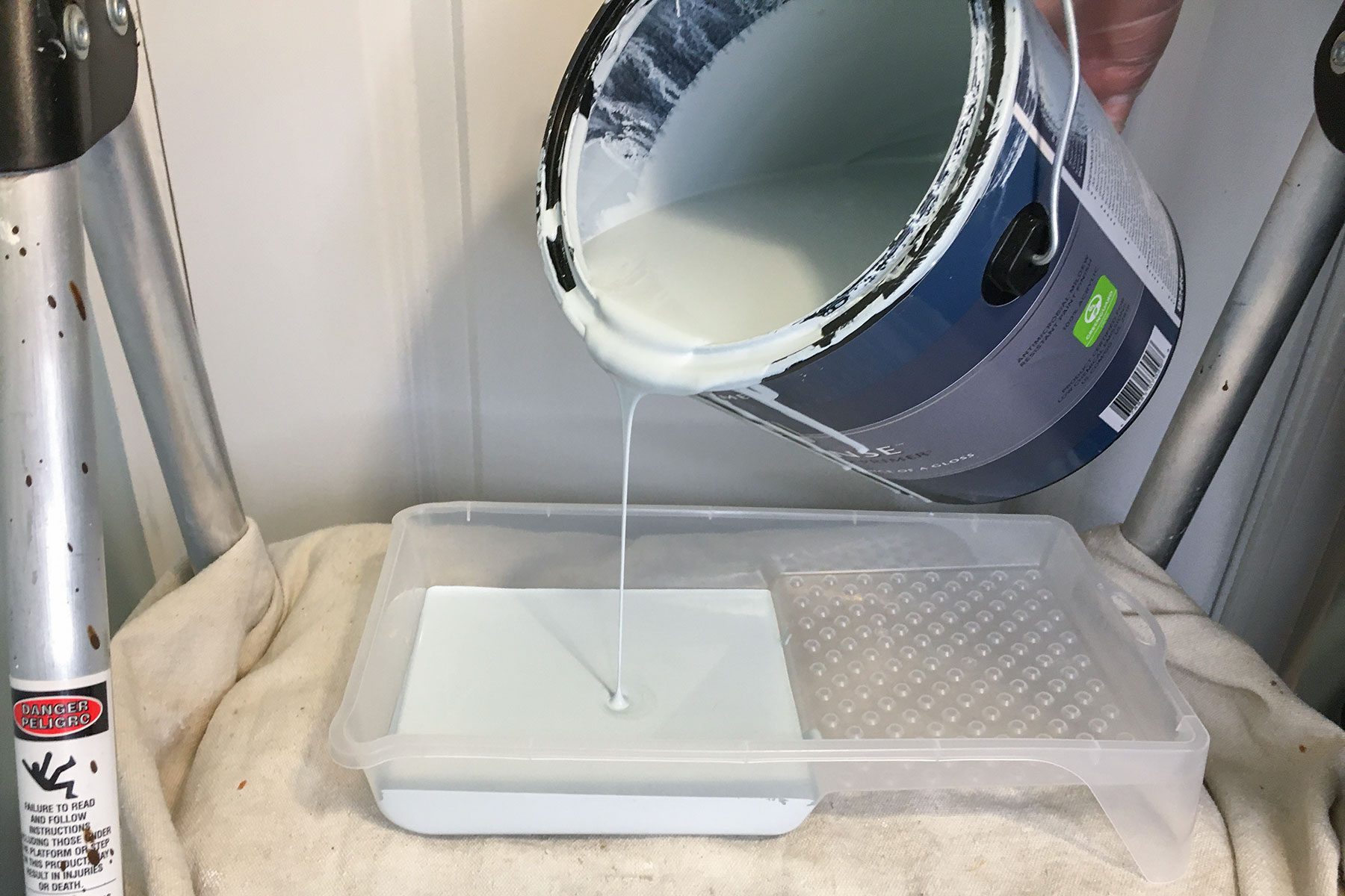 Pouring paint on paint tray
