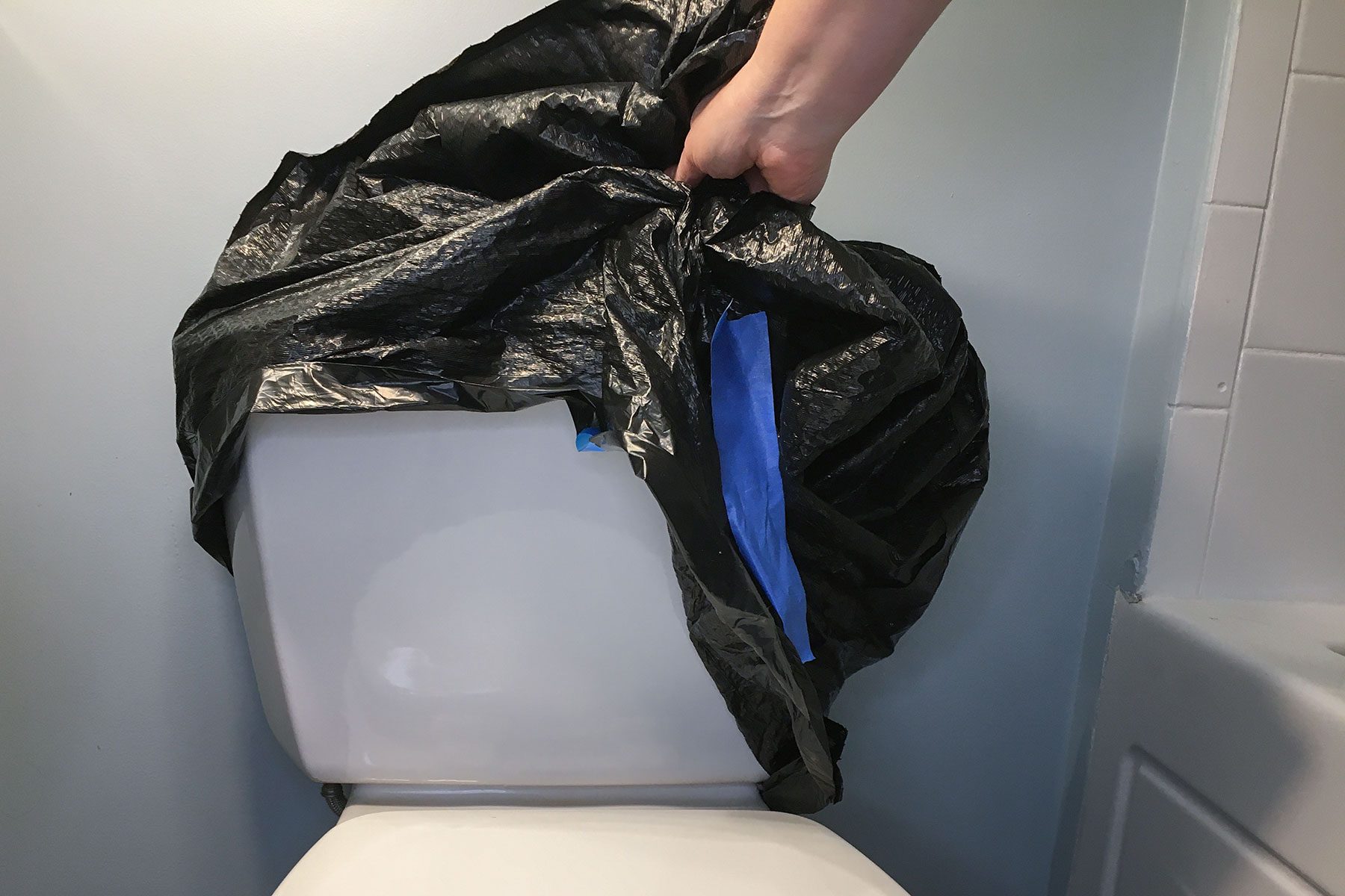 Removing the trash bag from toilet