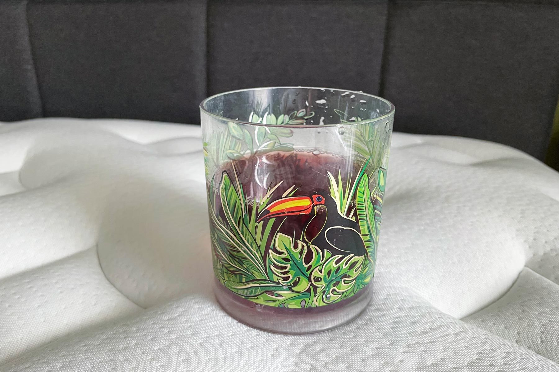 Cranberry juice on one side of the bed