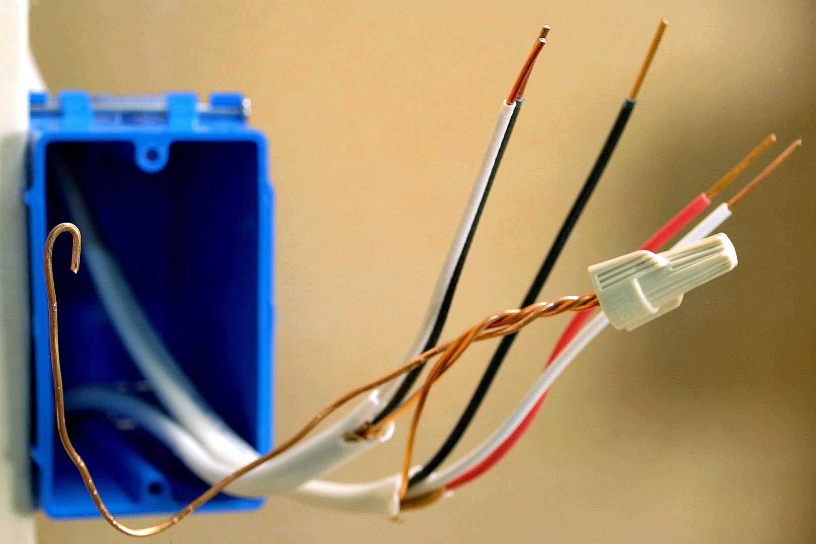 prepped wires for 3 way switch, one with a cap on it and the others stripped of the insulation