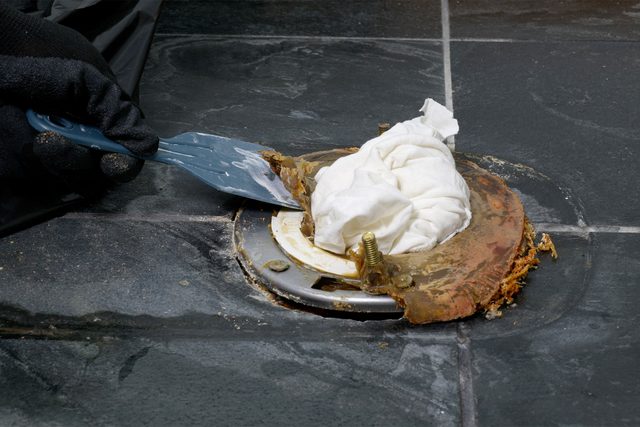 Scrapping off wax ring and flange from floor