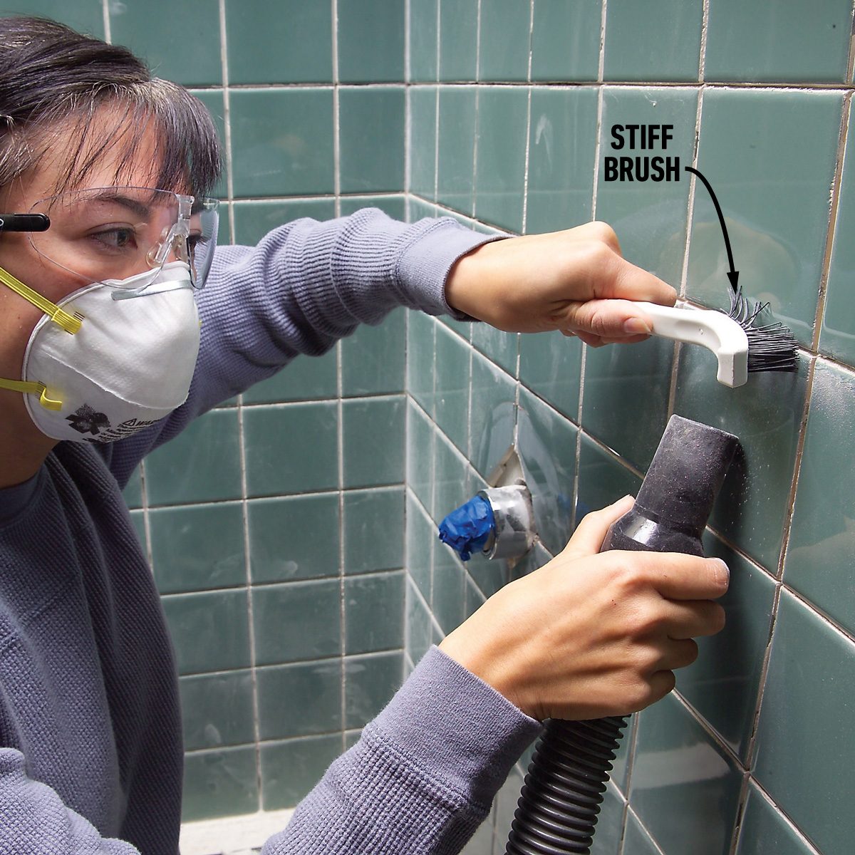 Slice out caulk and scratch out grout