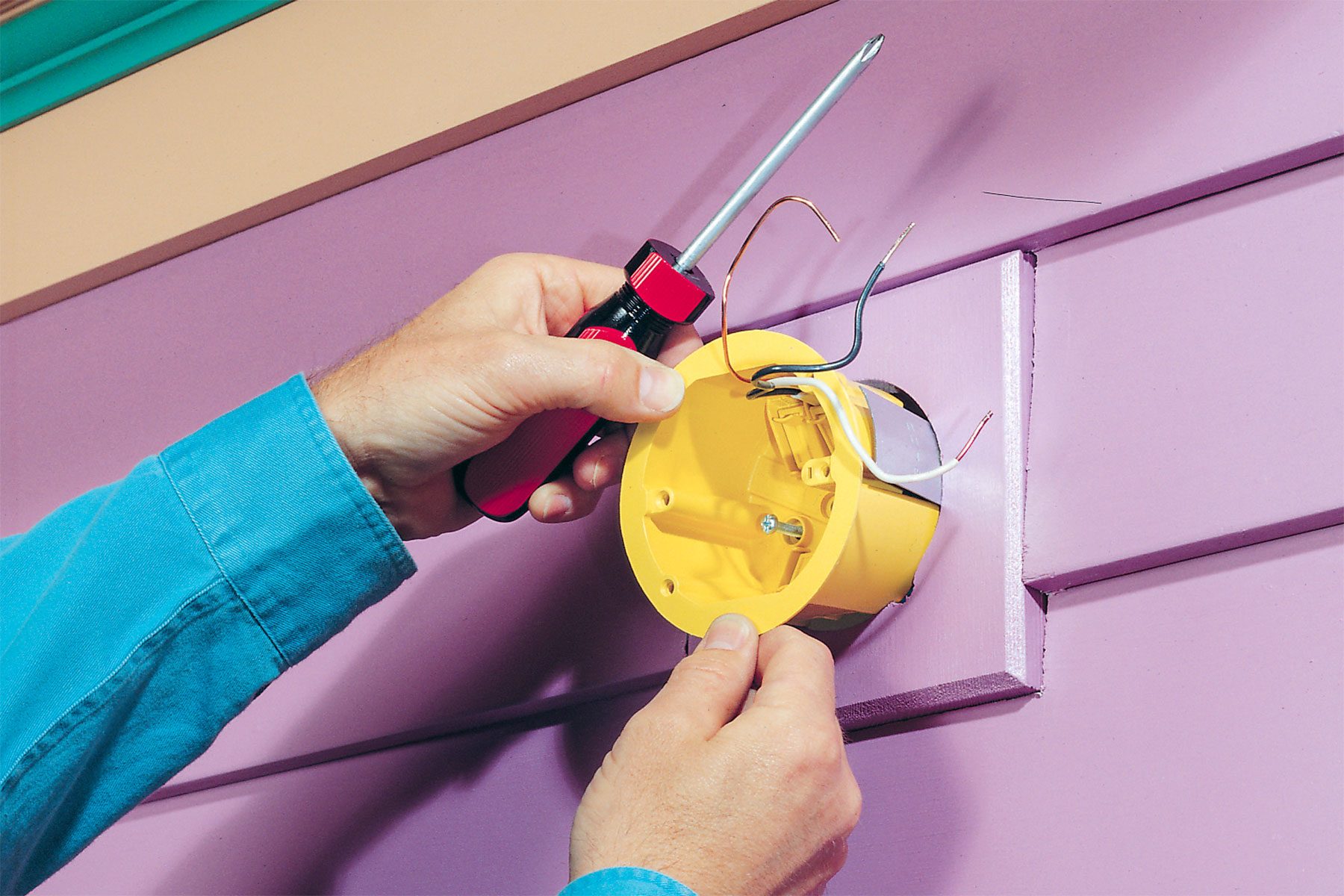 Wires run inside an electrical box.