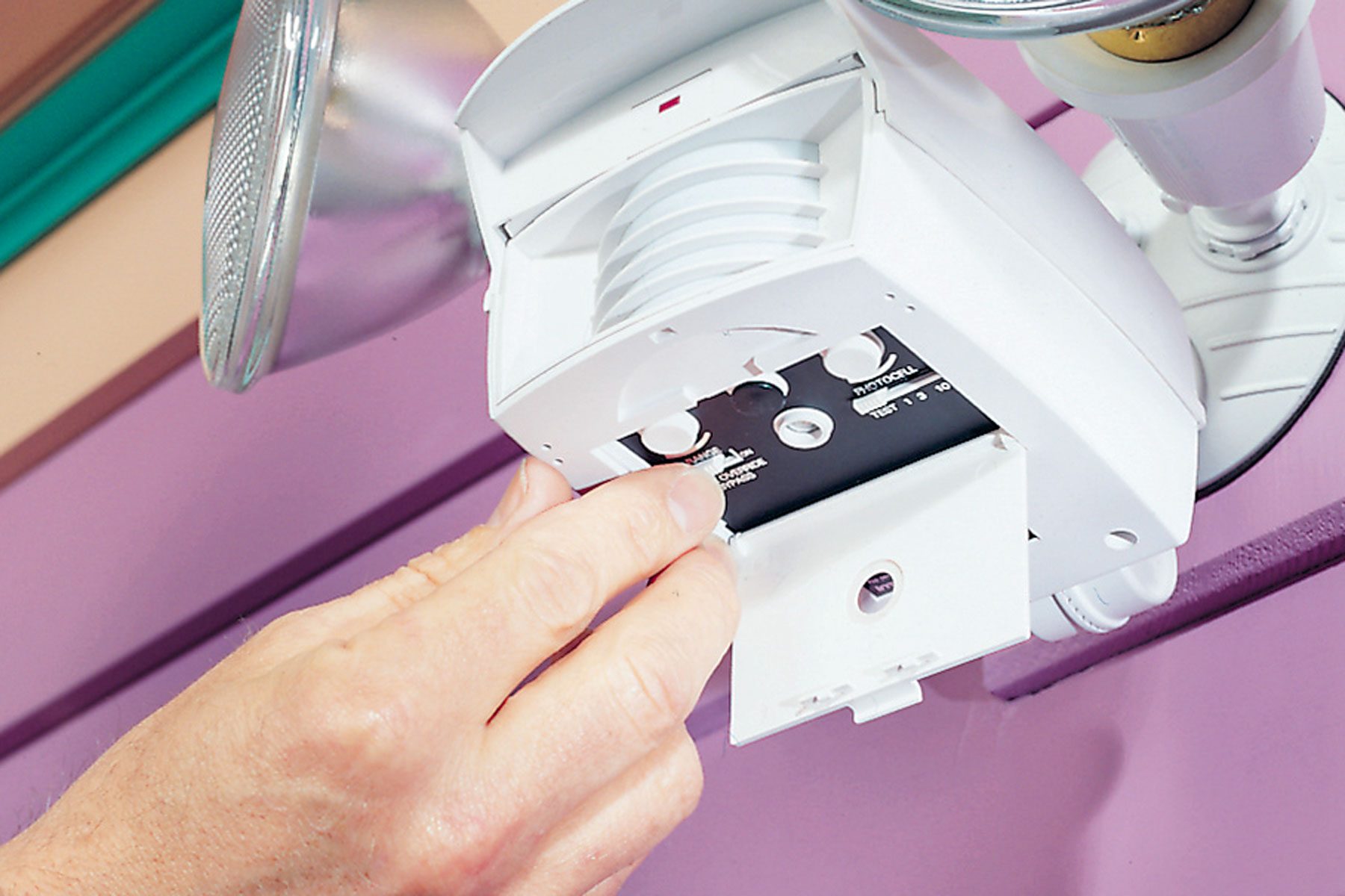 A hand can be seen adjusting sensor controls.