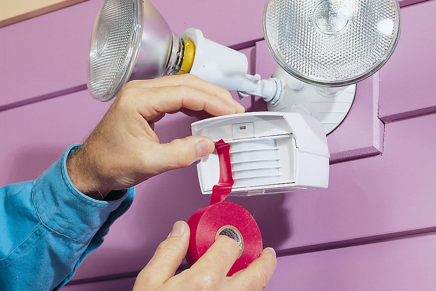 Hands can be seen using tape to adjust field of view of the sensor.