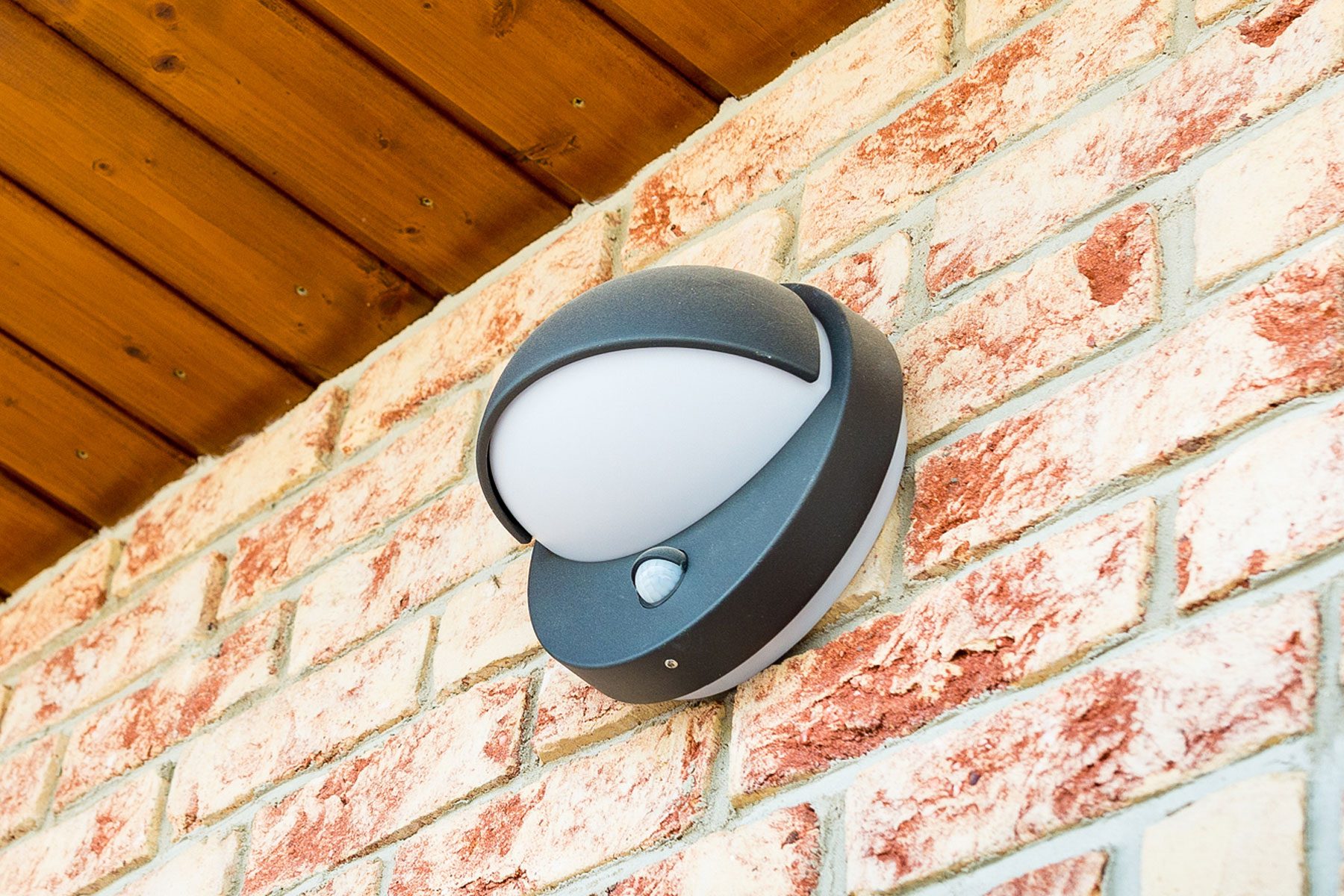 Motion Sensor Light on a brick wall.