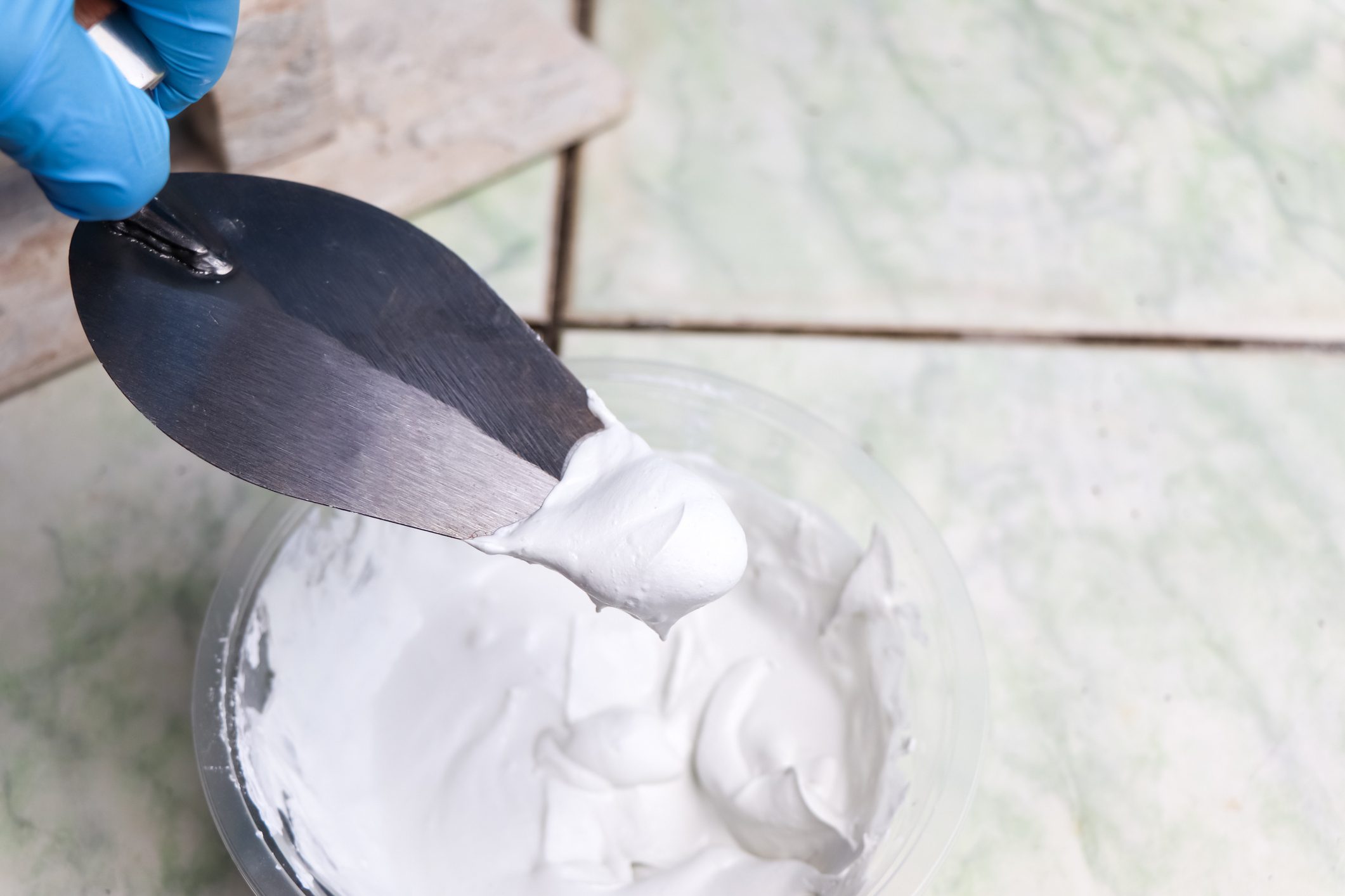 mixing grout in a bucket for mechanic work