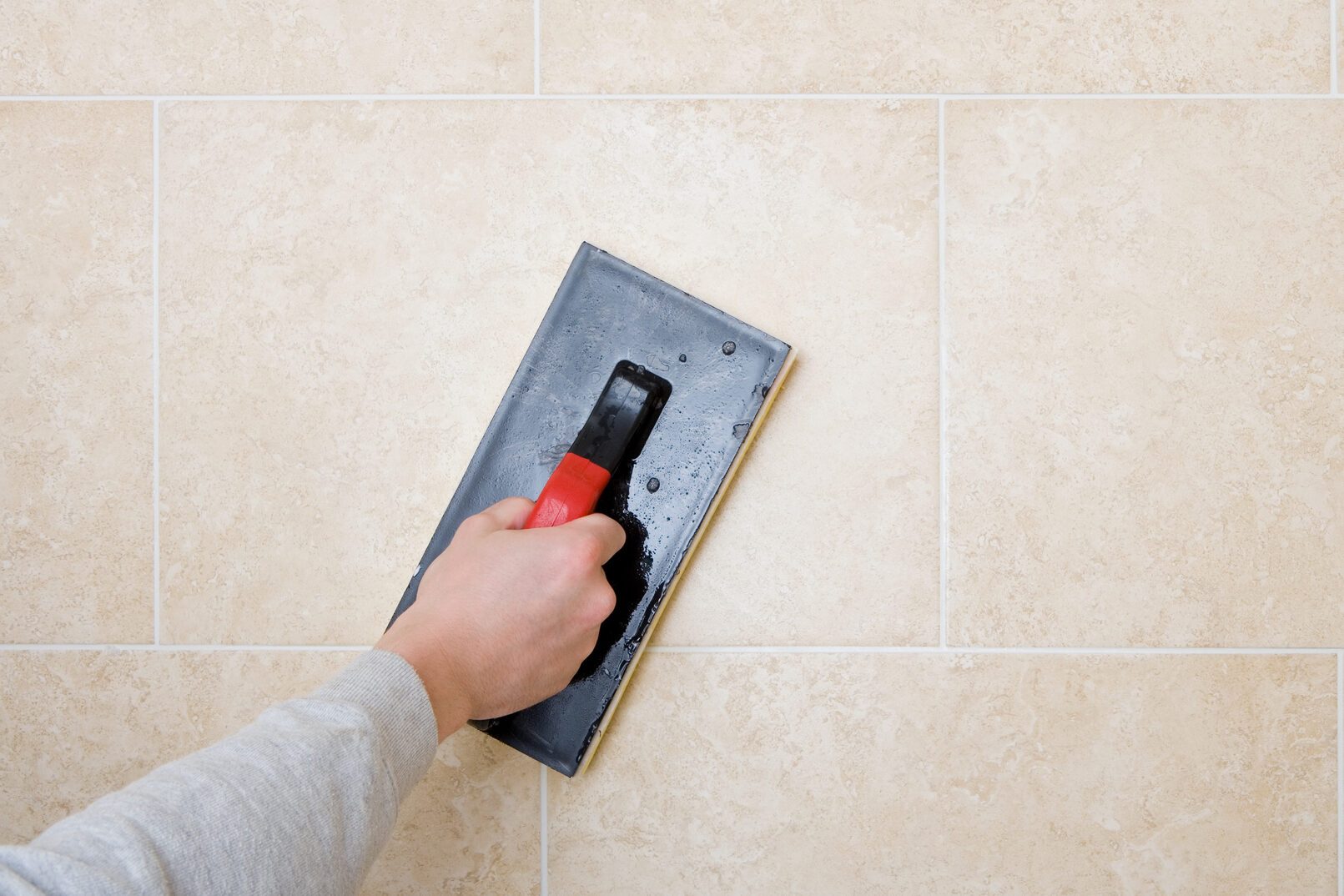 A decorator grouting tiles