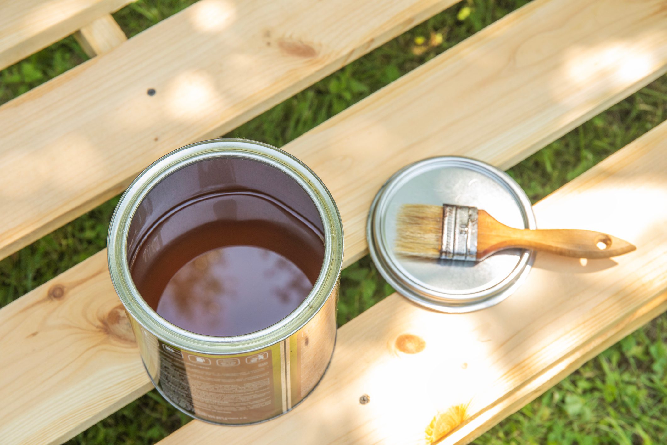Image of paint brush on the opened can with primer on the wooden table. painting and renovation repairing concept