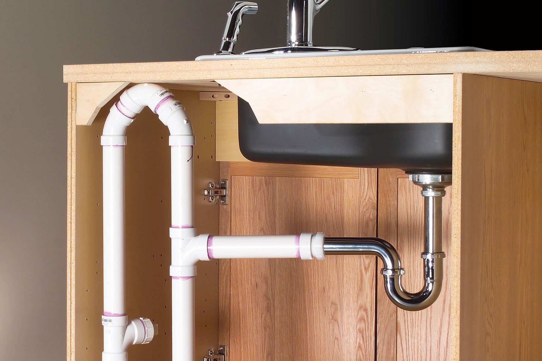 plumbing under a kitchen island sink