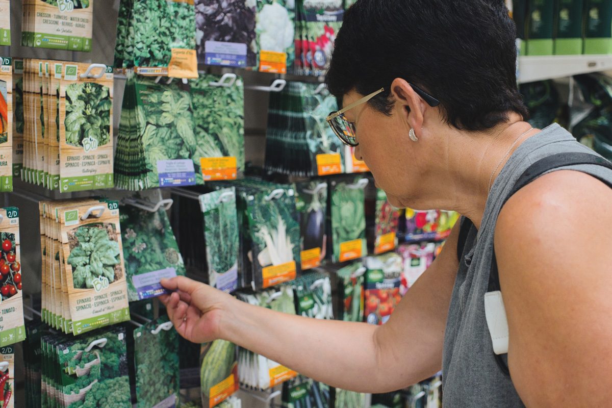 woman picking seed packets at a store