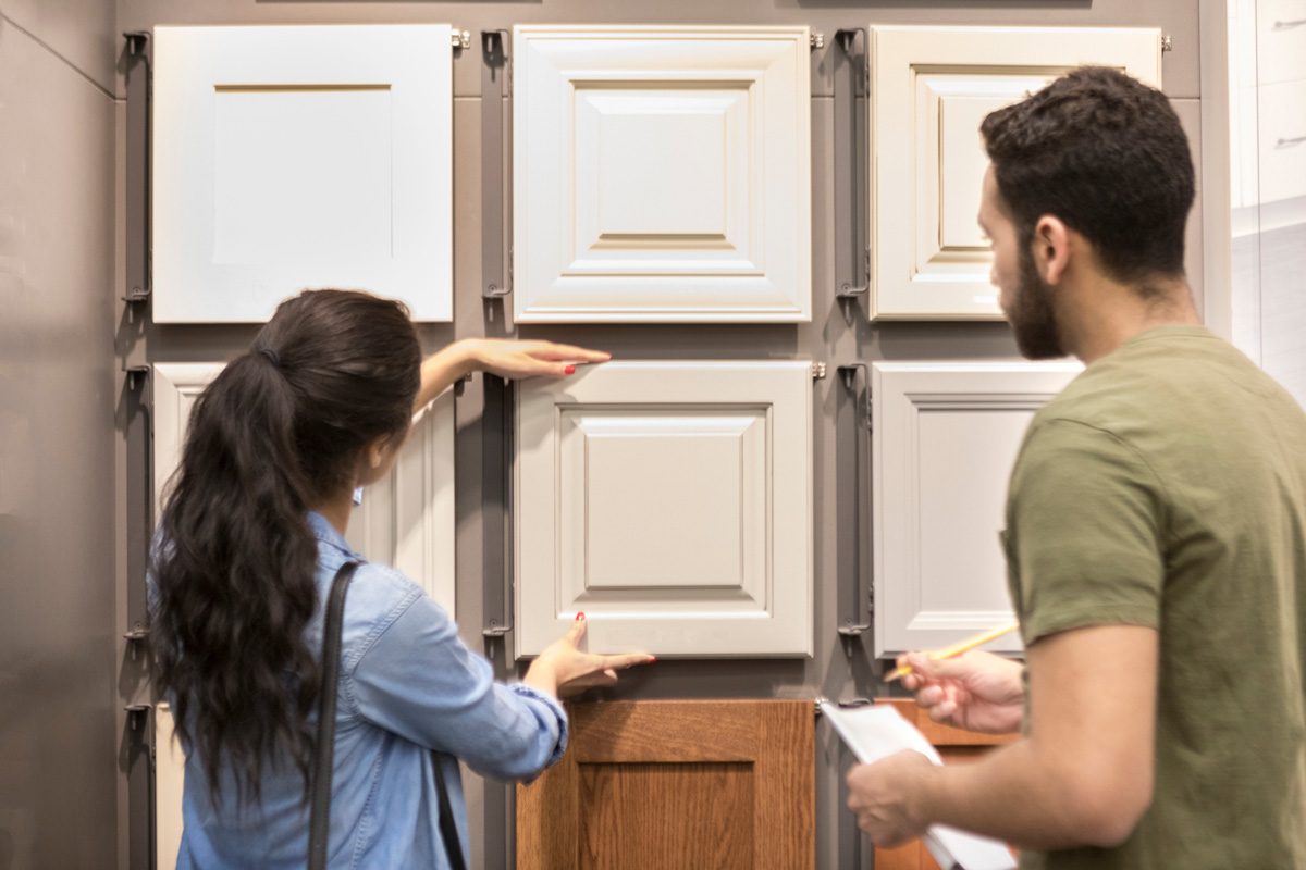 woman looks a cabinetry display in home improvement store