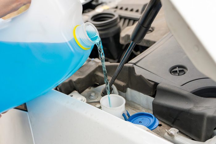 pouring antifreeze in engine