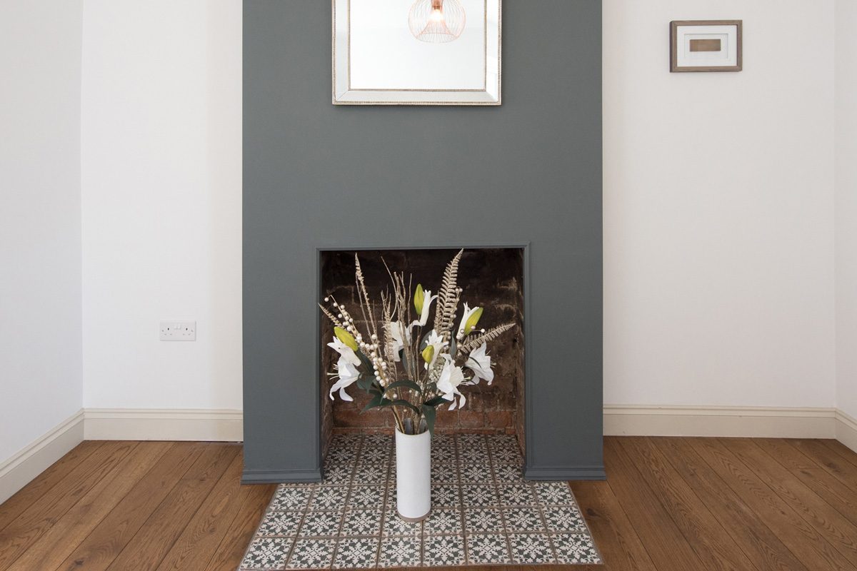 vase of flowers in a fireplace