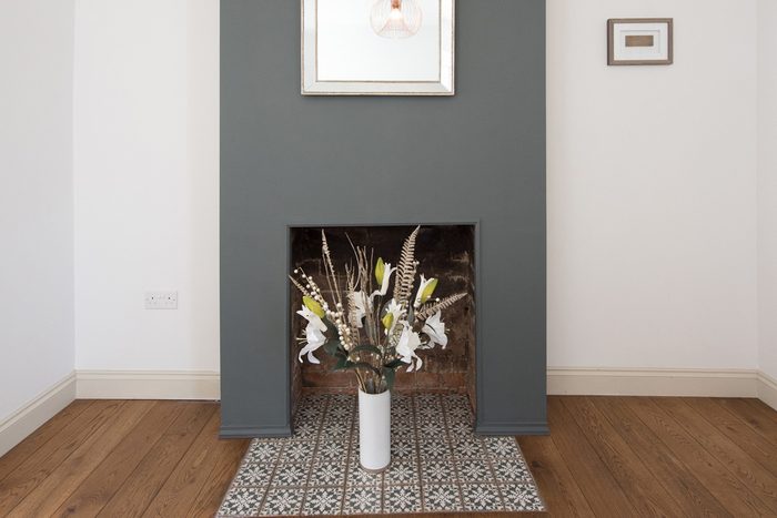 vase of flowers in a fireplace