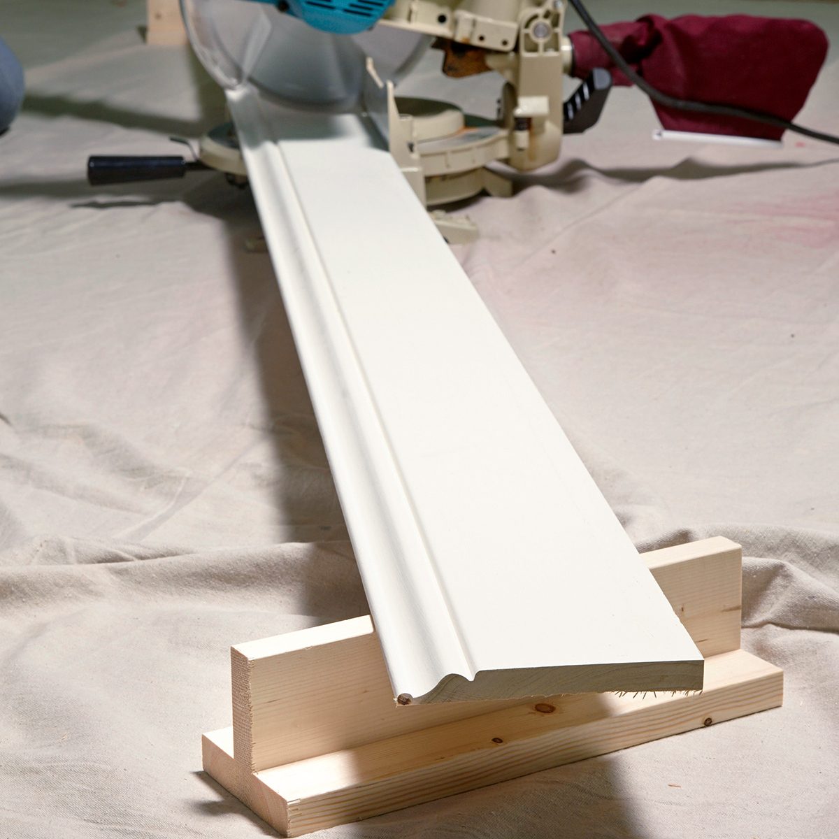 A woodworking machine cutting a white board.