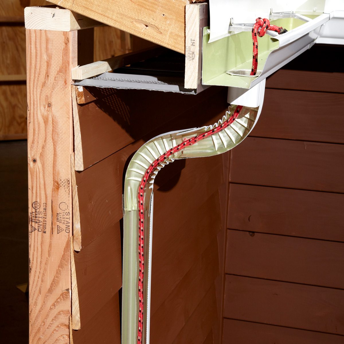 rope running down gutter downspout