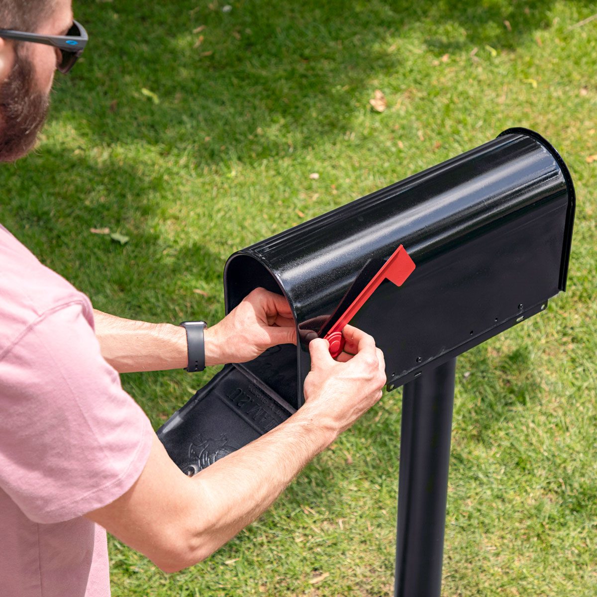 High-angle shot of assemble the mailbox part; grass background;