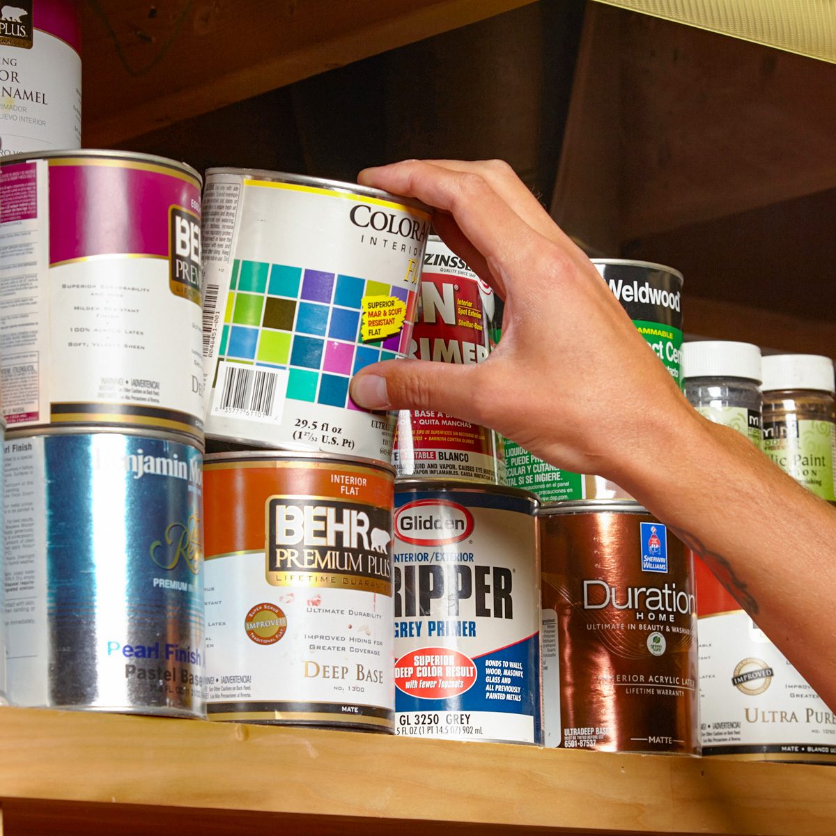 picking paint container off shelf