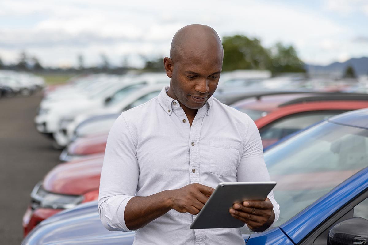 A person checking car manual on his tablet