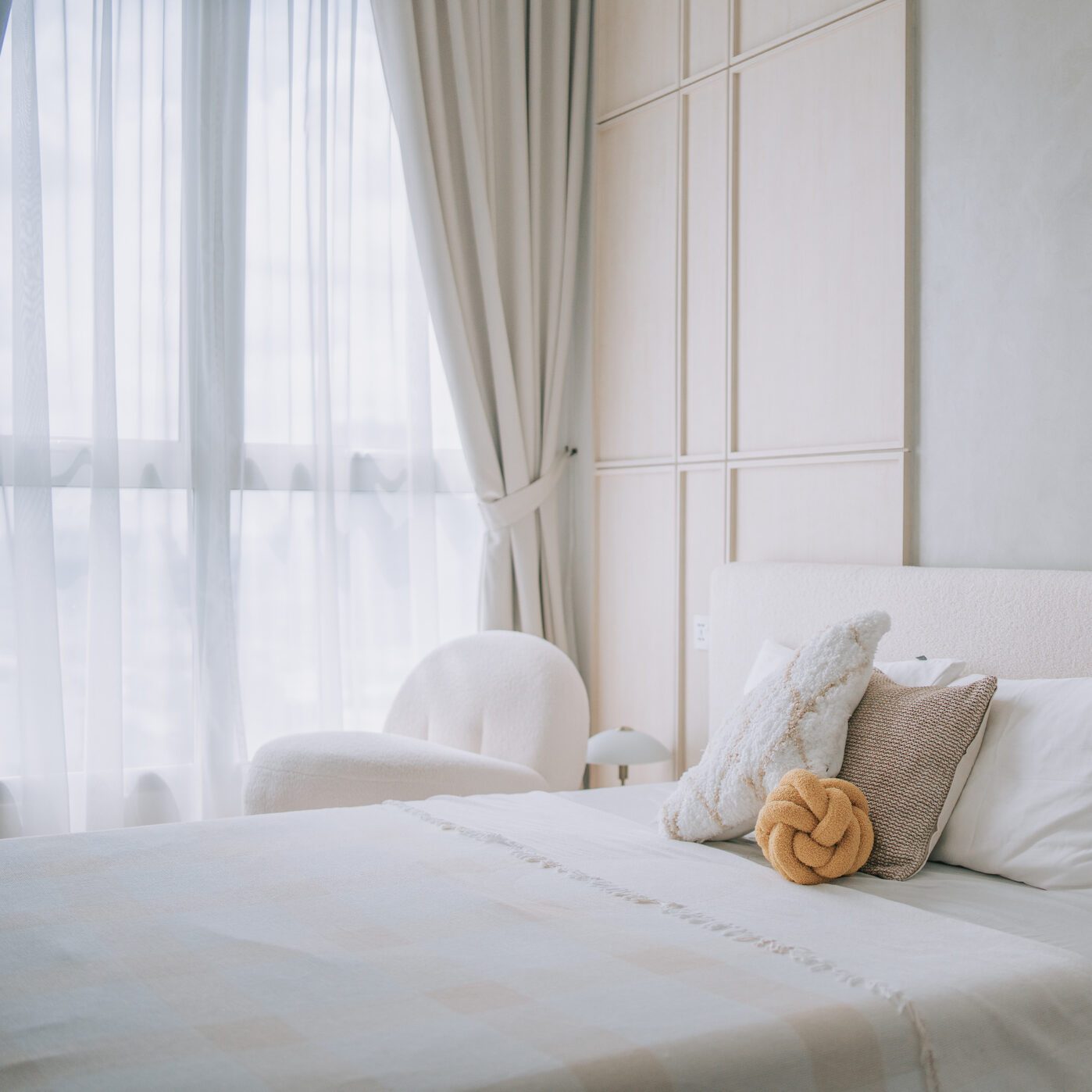 brightly lit bedroom beside window