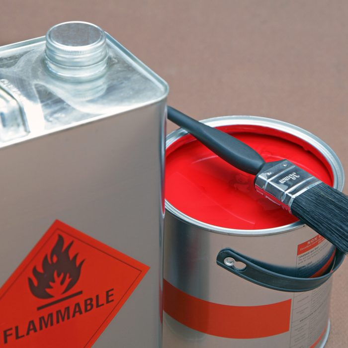 open tin of paint and cleaning solvent