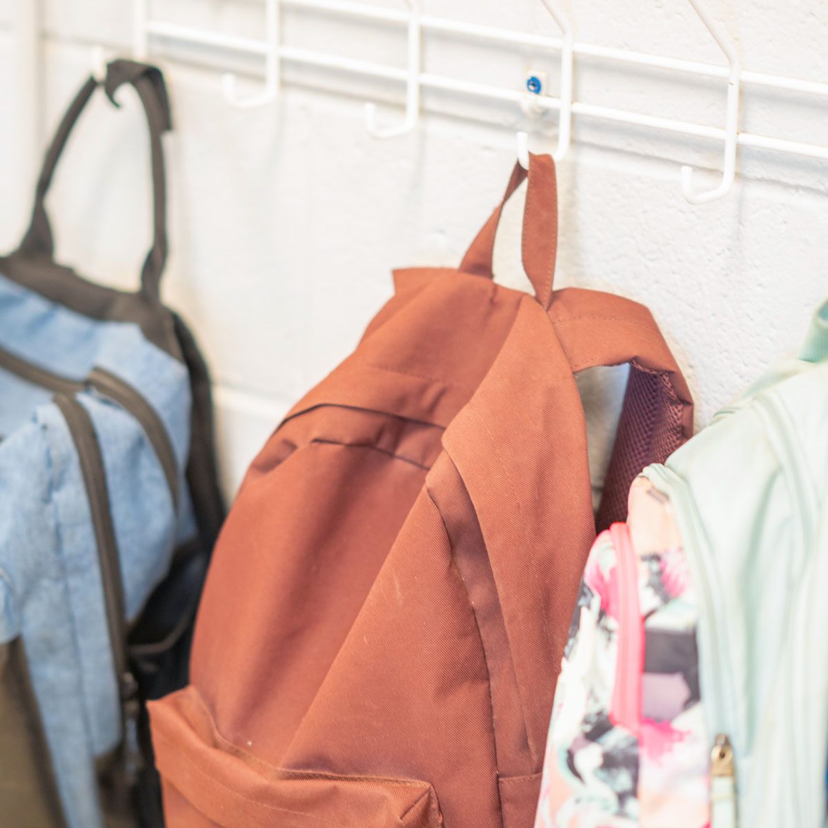 backpacks hanging on hooks