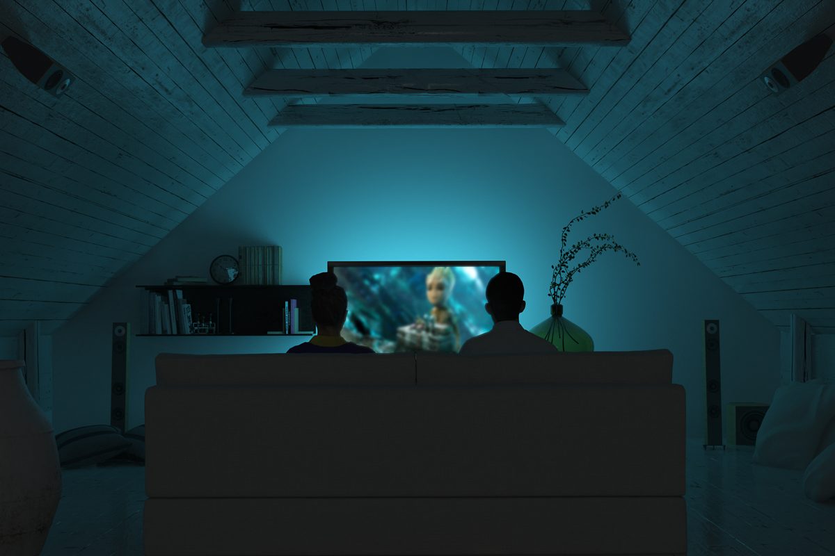 couple watching a movie in home theatre