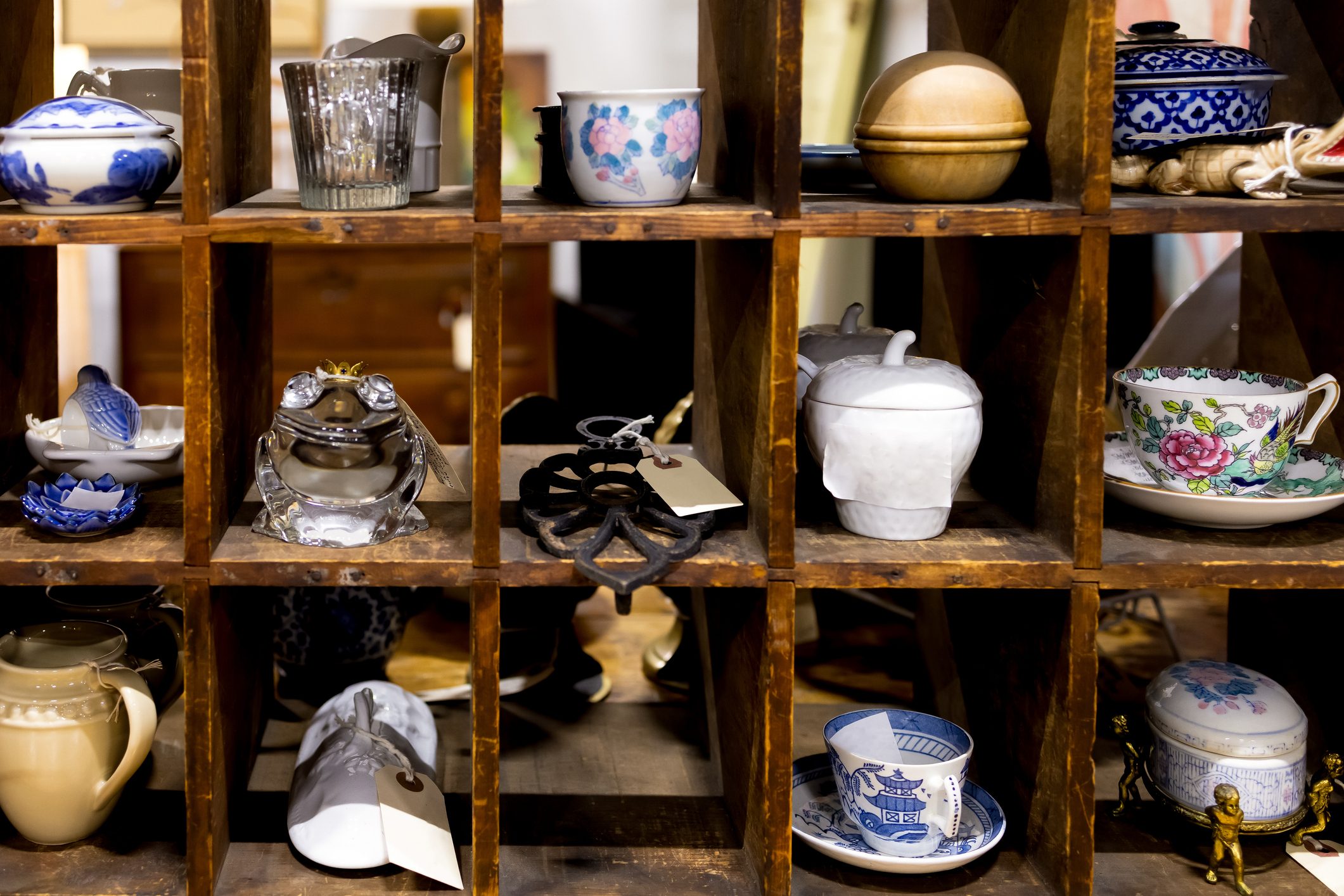 antique knick knacks in cubby hole compartments at vintage flea market